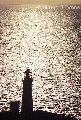 South Stack lighthouse silhouetted against the sea
